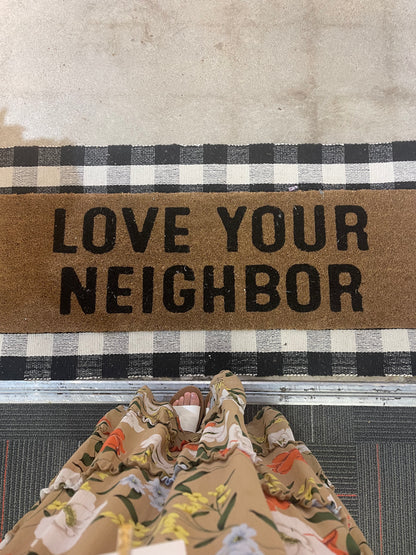 Love Your Neighbor coir doormat layered over the black-and-white Buffalo Plaid runner, viewed from above