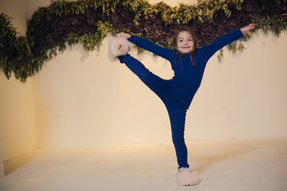 Organic Baby + Kids Pajama Set | Navy Peony — Child stretching in navy pajamas
