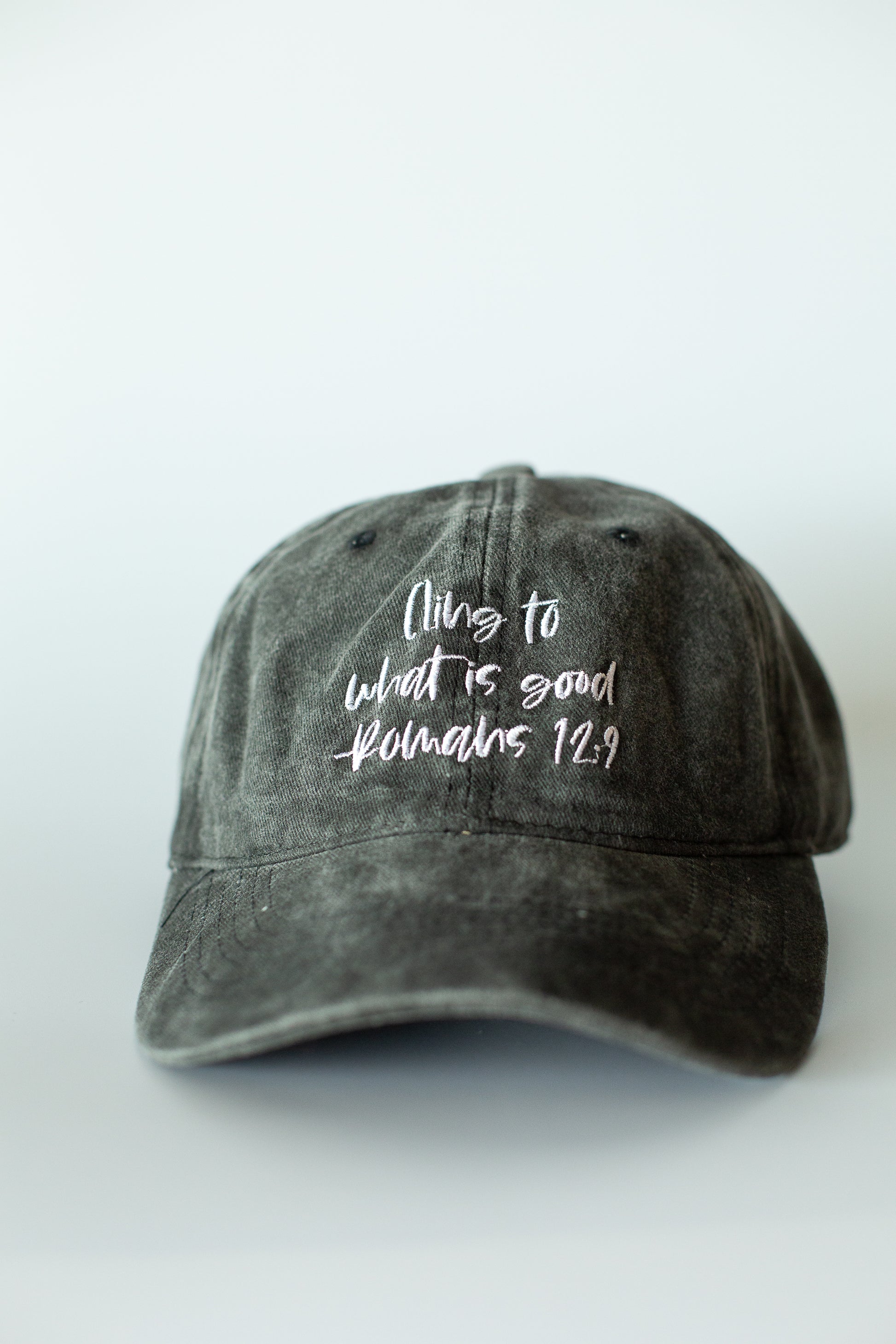 Romans 12:9 Cling to What Is Good washed black baseball cap by Modern Burlap