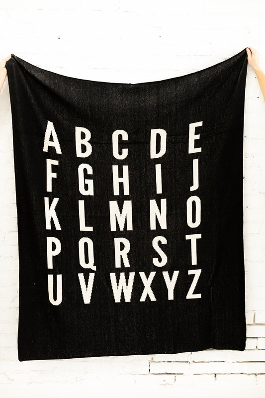ABC Recycled Cotton Throw Blanket — Black, showing the knitted design.