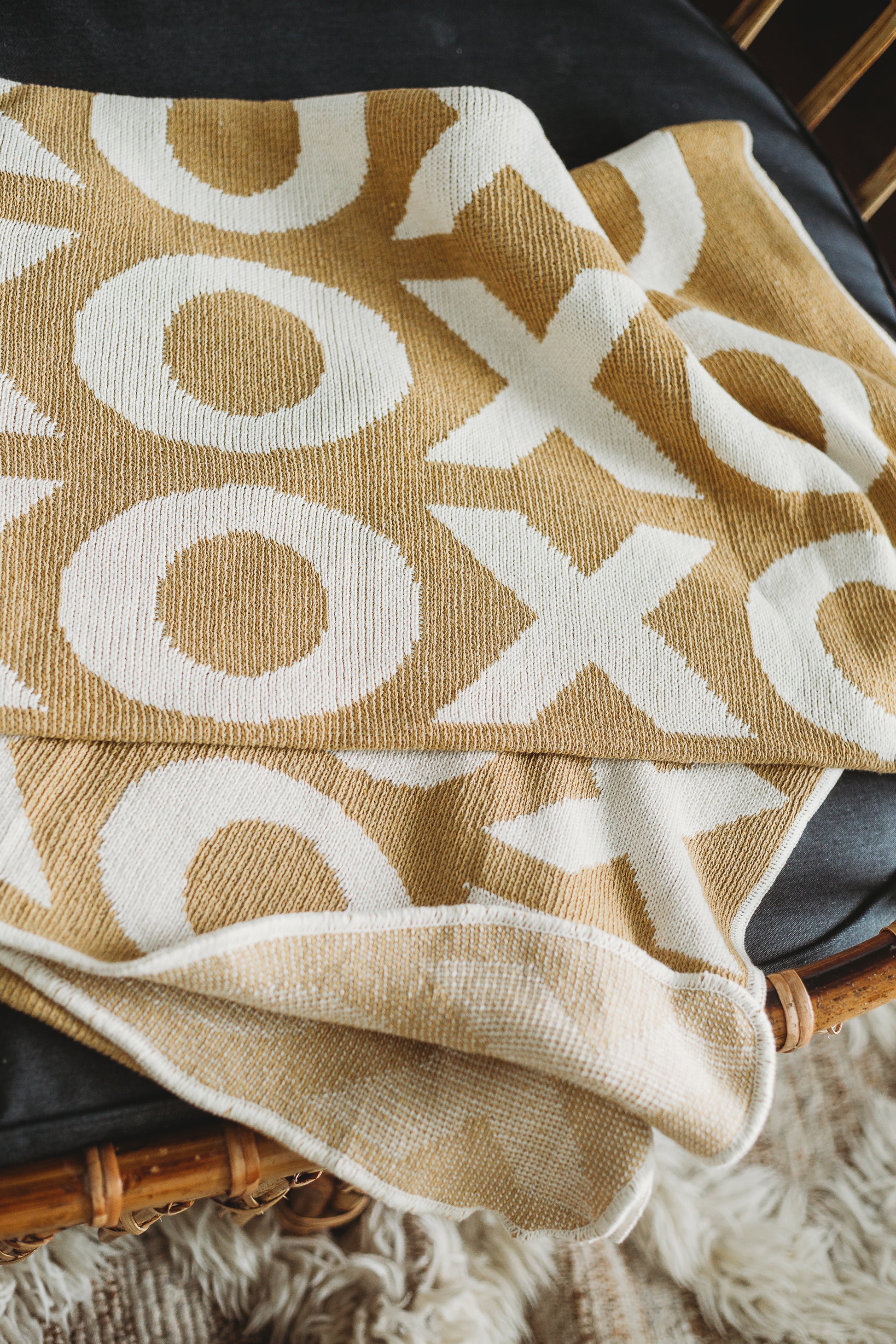 Modern Burlap XO blanket in a home setting