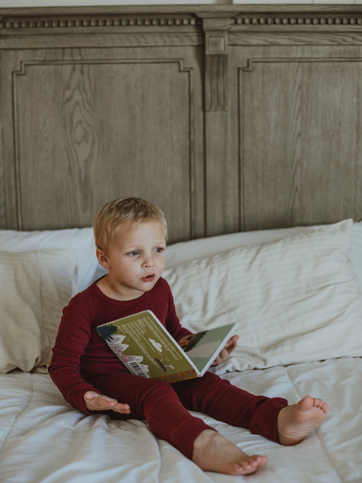 Organic Thermal Baby + Kids Pajama Set | Maroon — Child reading in the full pajama set