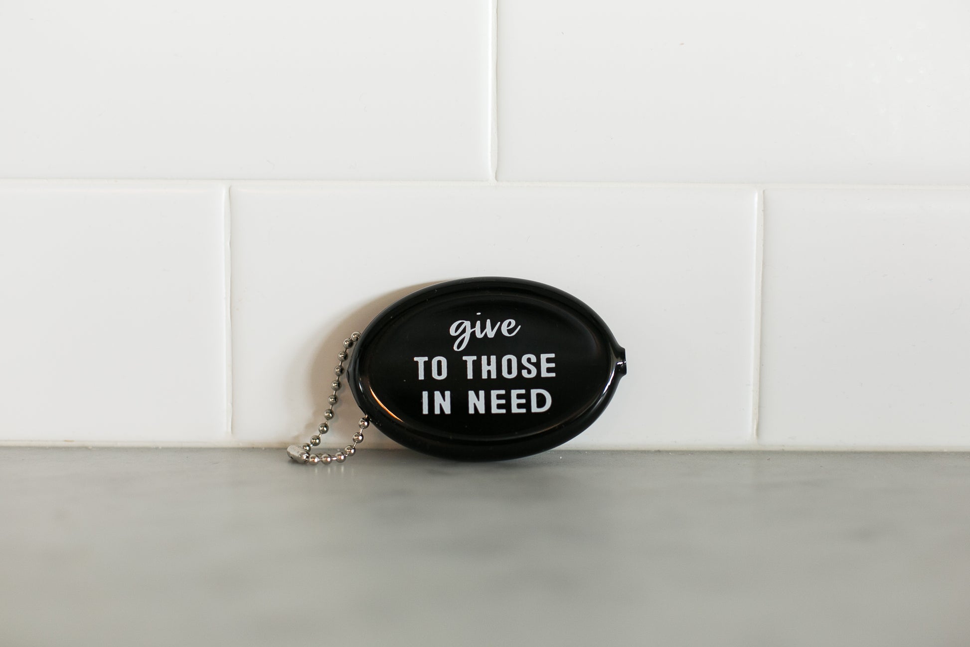 Black vintage coin pouch for intentional giving by Modern Burlap