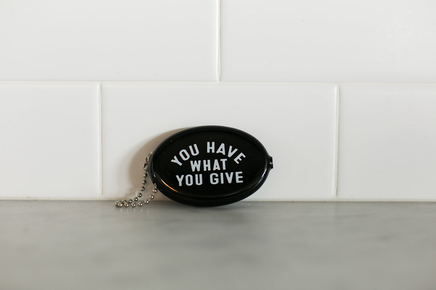 Black vintage coin pouch for intentional giving by Modern Burlap