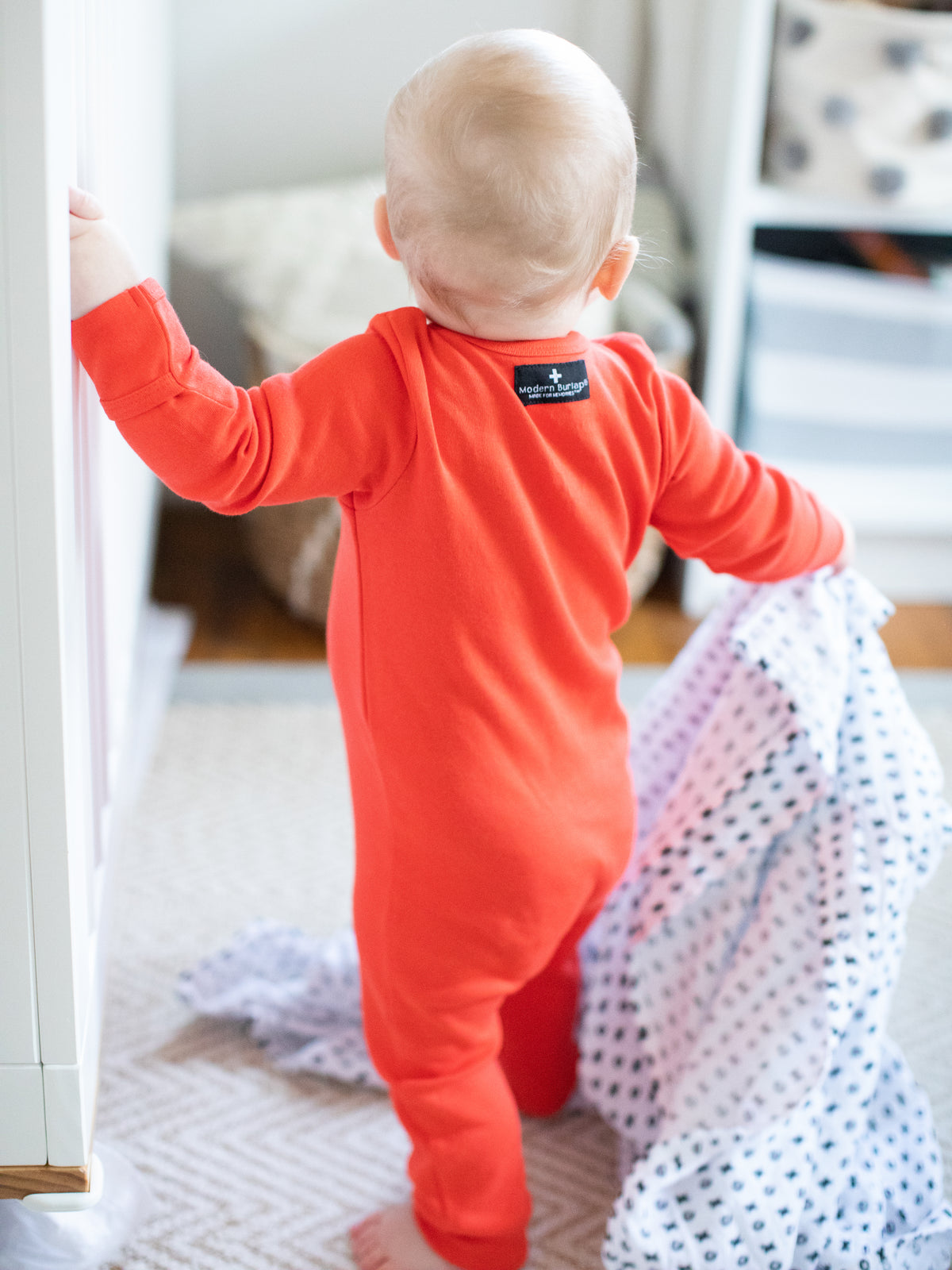 Back view of a child wearing a bright red coverall