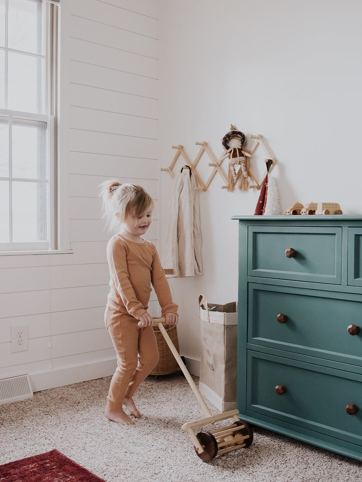 Organic Thermal Baby + Kids Pajama Set | Ginger — Child standing in pajamas beside a dresser