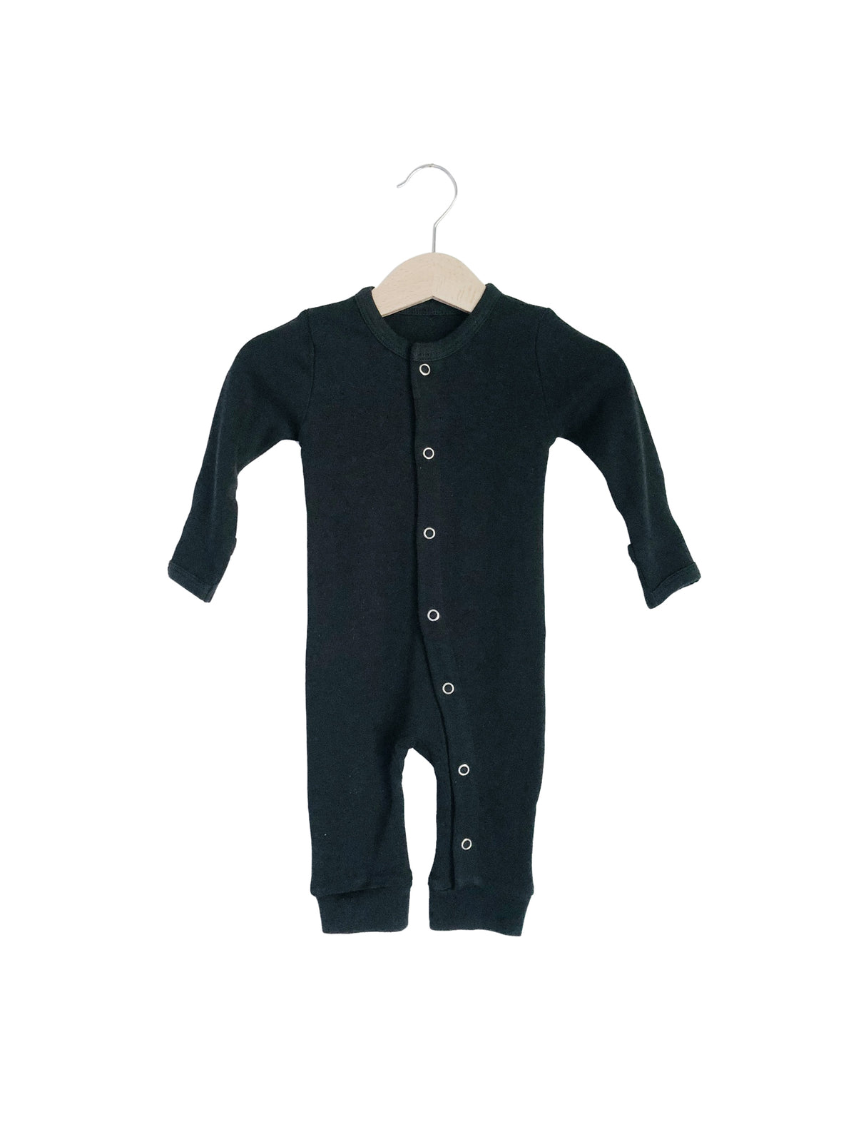 Black button coverall on a hanger, showing the front closure and ankle cuffs