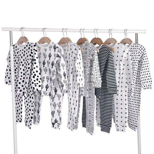 Assorted black-and-white printed pajama sets displayed on a clothing rack