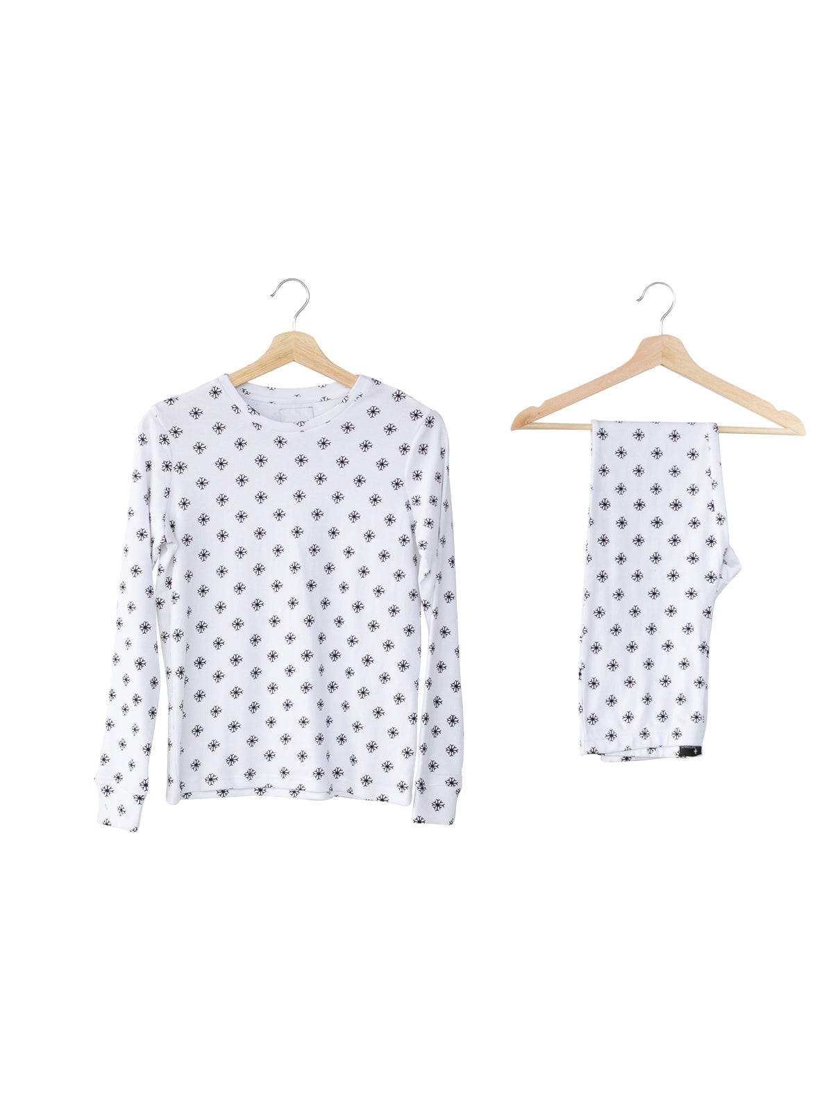 Organic Baby + Kids Pajama Set | Black on White Snowflakes — Printed pajama top and matching pants on hangers