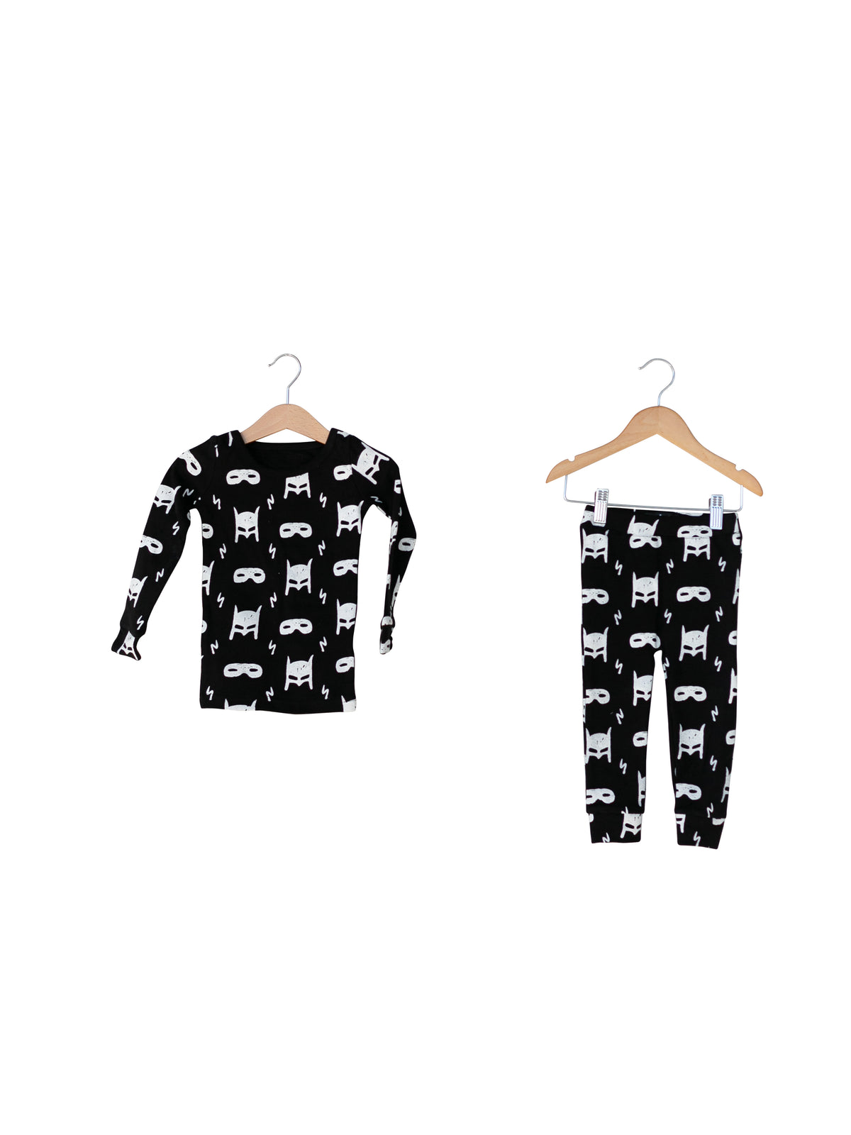 Organic Baby + Kids Pajama Set | White on Black Hero Struck — Printed pajama top and matching pants on hangers