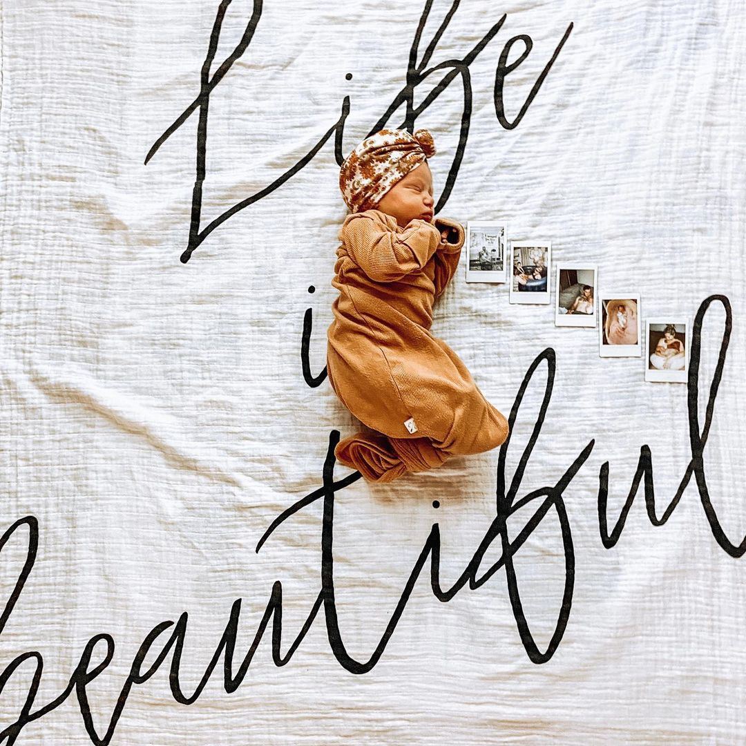 Baby or child pictured with Life Is Beautiful Organic Swaddle.