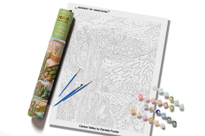 Cactus Valley paint-by-numbers kit showing numbered desert canvas, paints, brushes and storage tube.