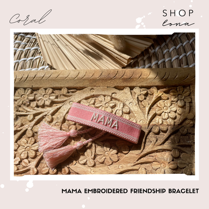 shop LONA MAMA embroidered bracelet in Coral, shown with its pink band and tassel ends.