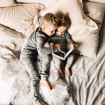 Organic Baby + Kids Pajama Set | Neutral Gray — Children reading in matching gray pajamas