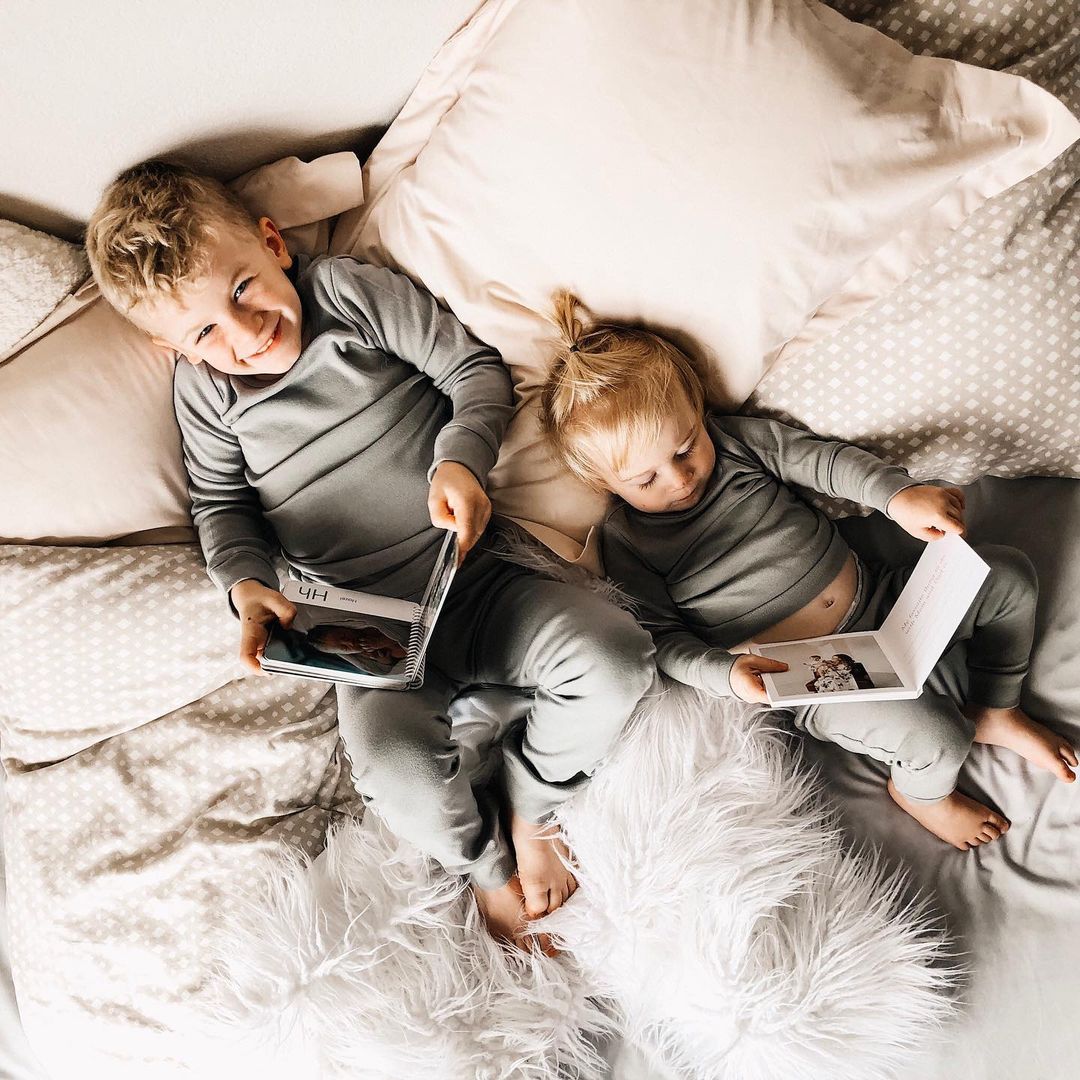 Organic Baby + Kids Pajama Set | Neutral Gray — Children reclining in matching gray pajamas