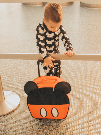 Organic Baby + Kids Pajama Set | White on Black Modern Mouse — Child wearing the set beside a character bag