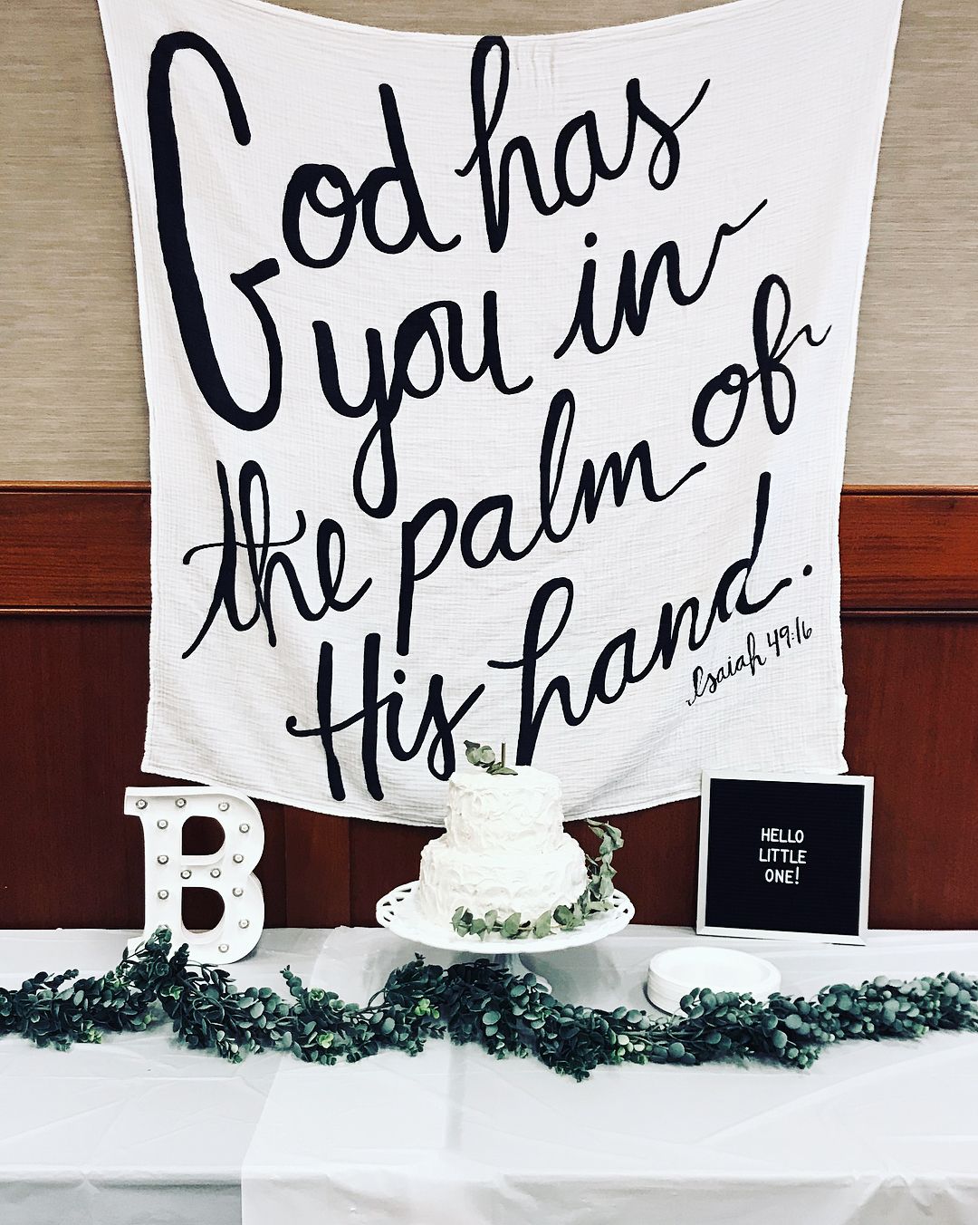 Isaiah 49:16 organic cotton muslin swaddle in a nursery setting