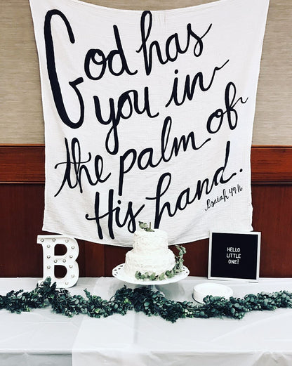 Isaiah 49:16 organic cotton muslin swaddle in a nursery setting