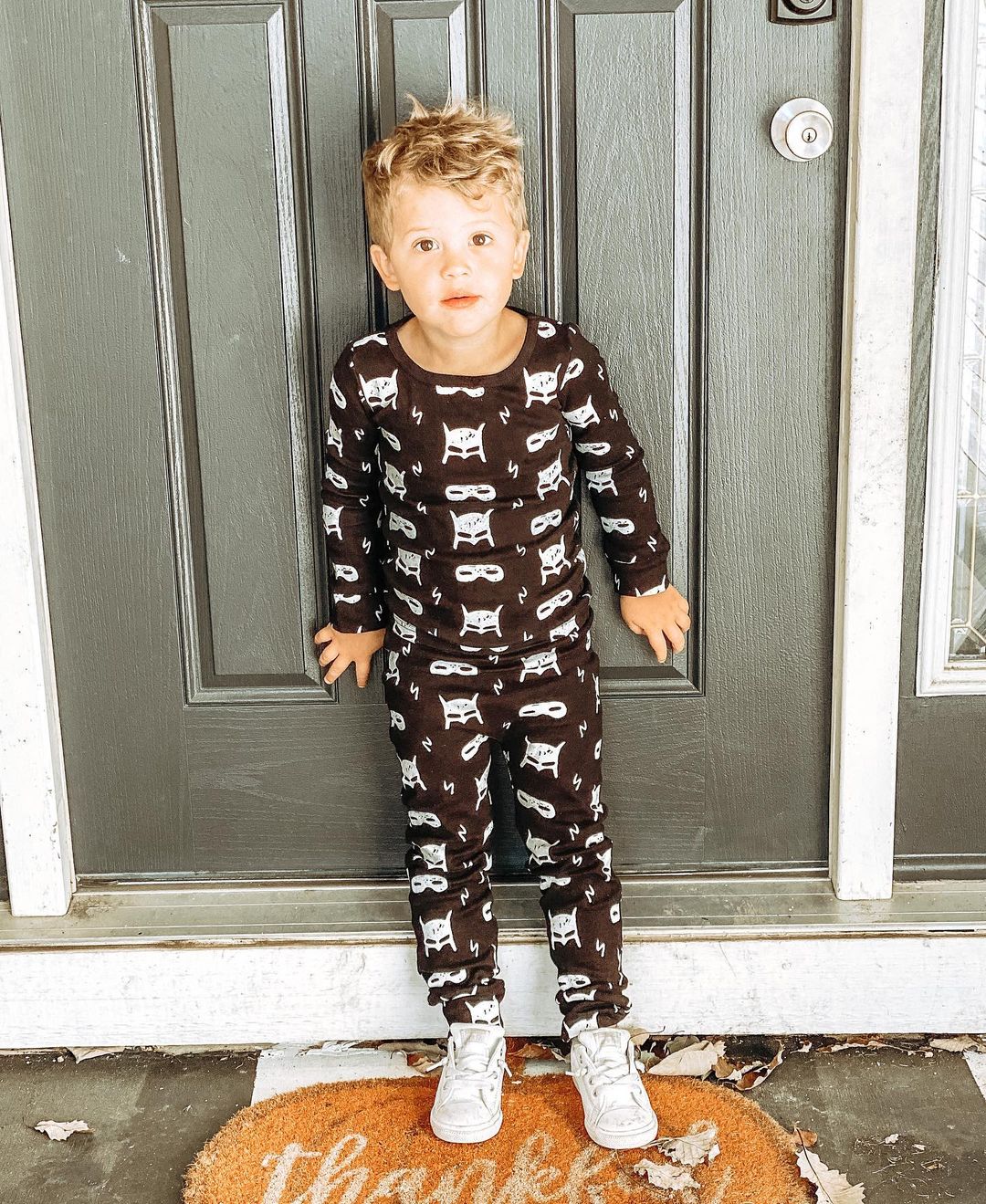 Organic Baby + Kids Pajama Set | White on Black Hero Struck — Full-length front view of child wearing the set