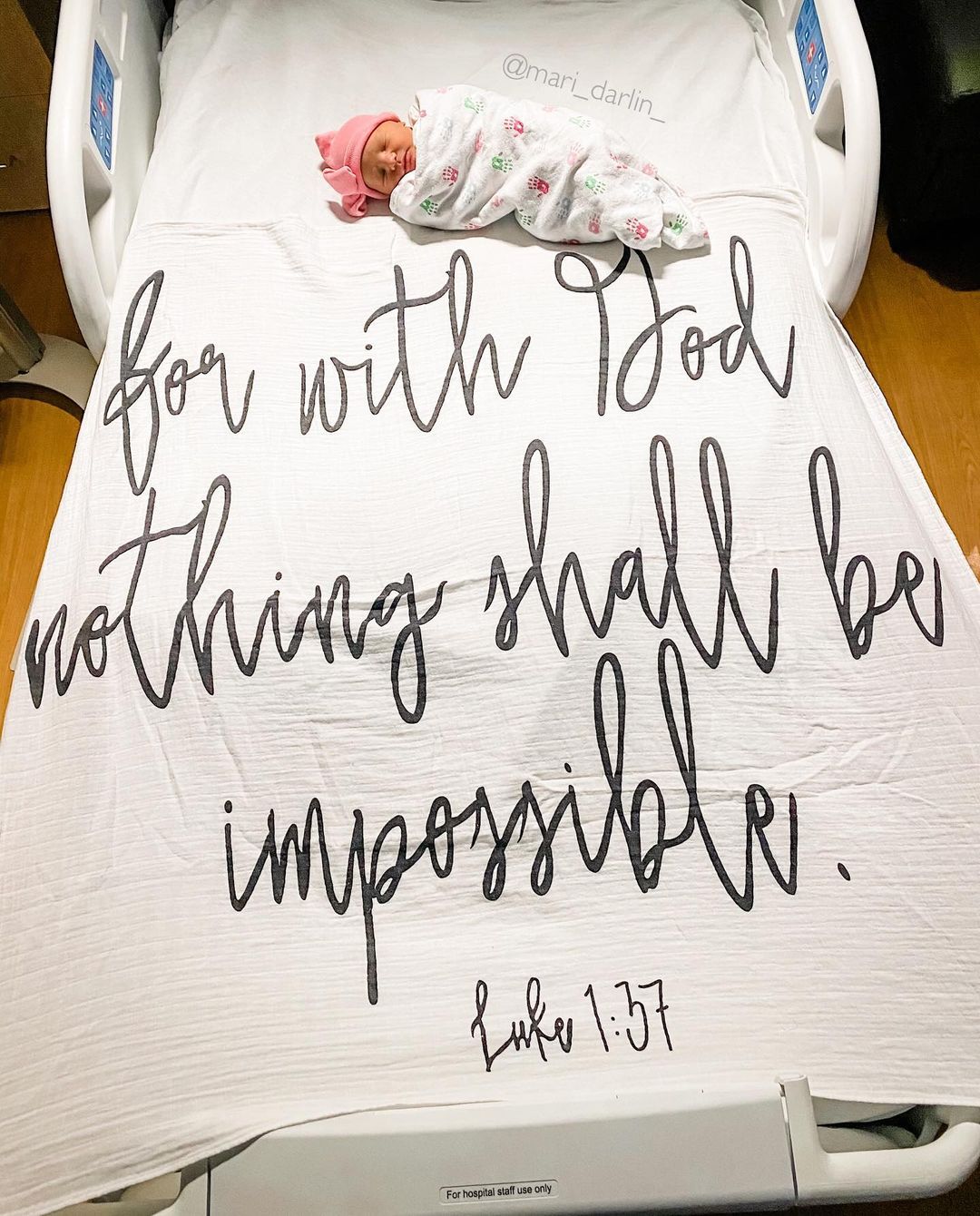 Parent pictured with baby and Luke 1:37 Scripture Swaddle.